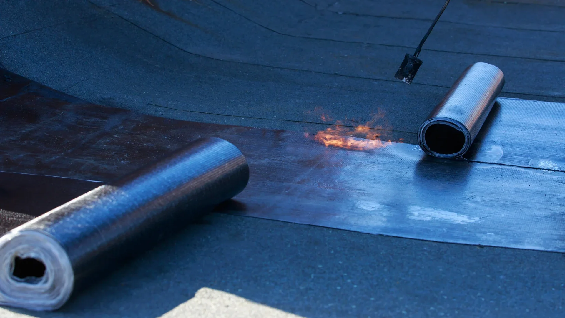 Installing new rubber roofing with a gas torch