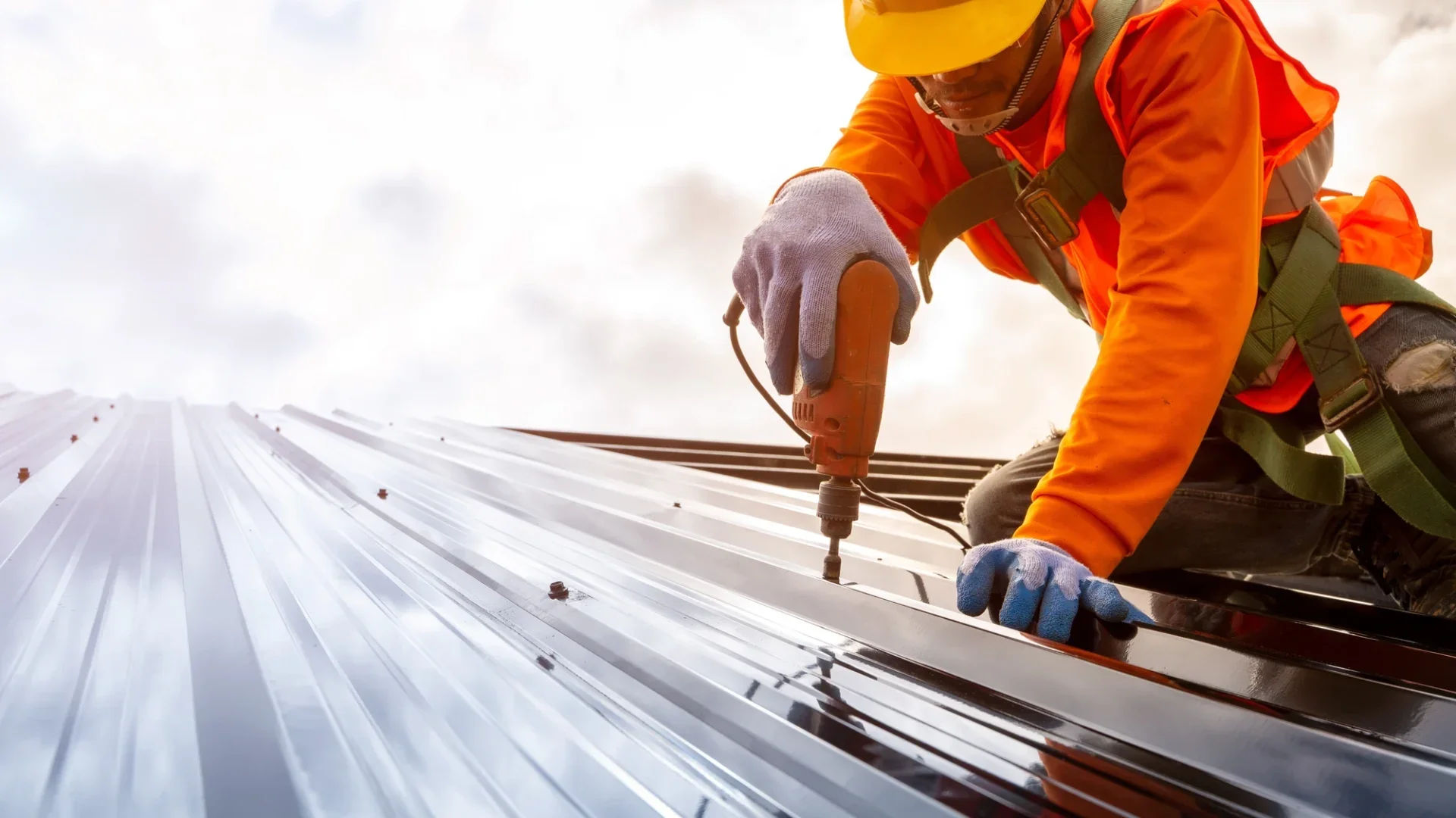 Worker installing metal roof